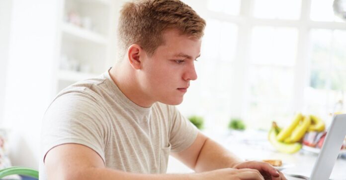 teenage-boy-studying-on-laptop-at-home